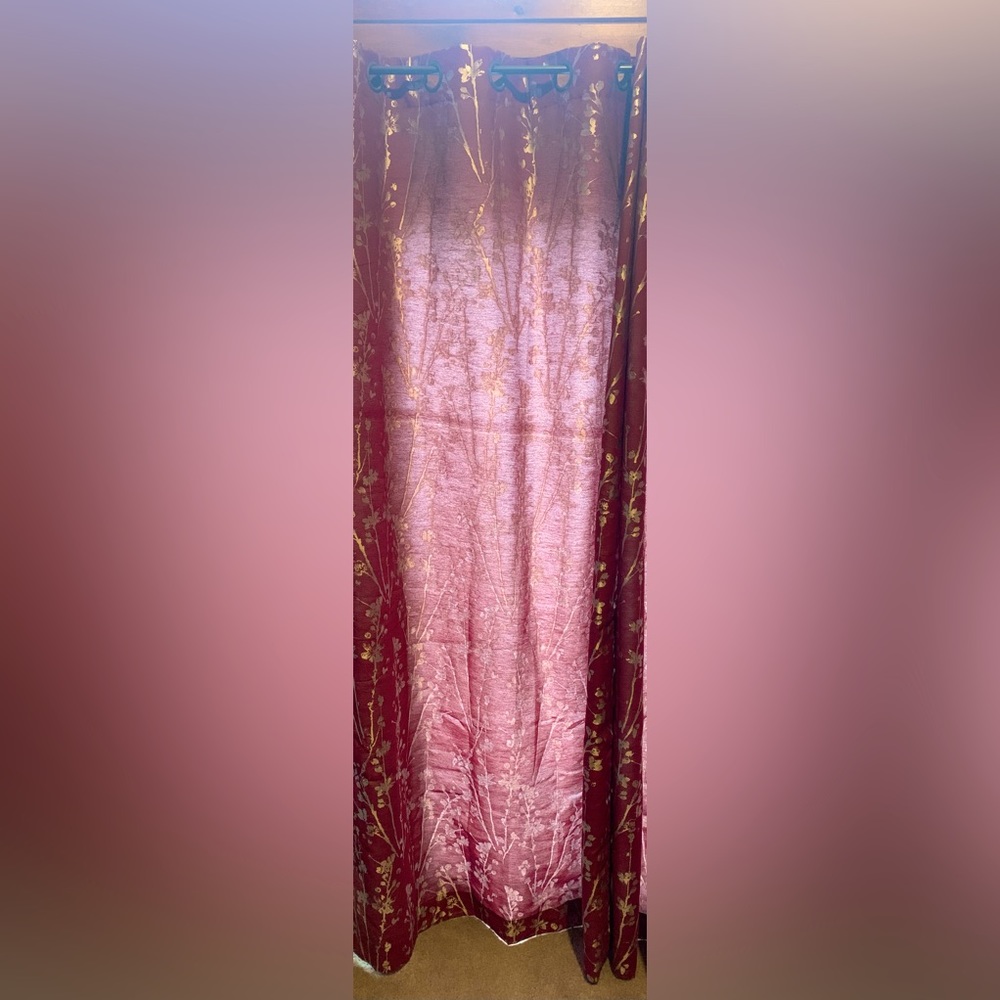 Two grommet style red curtains